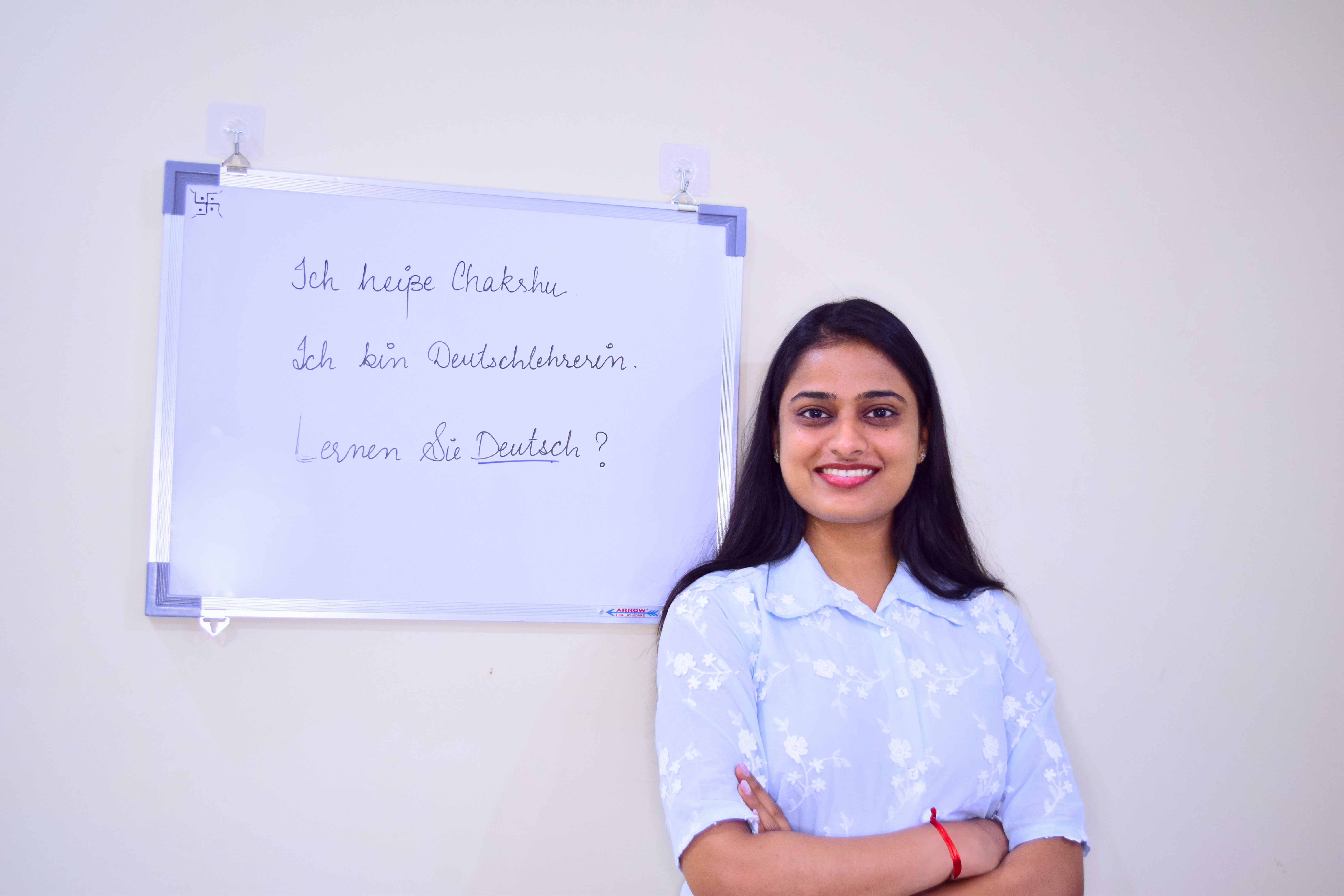 Chakshu teaching German at a whiteboard